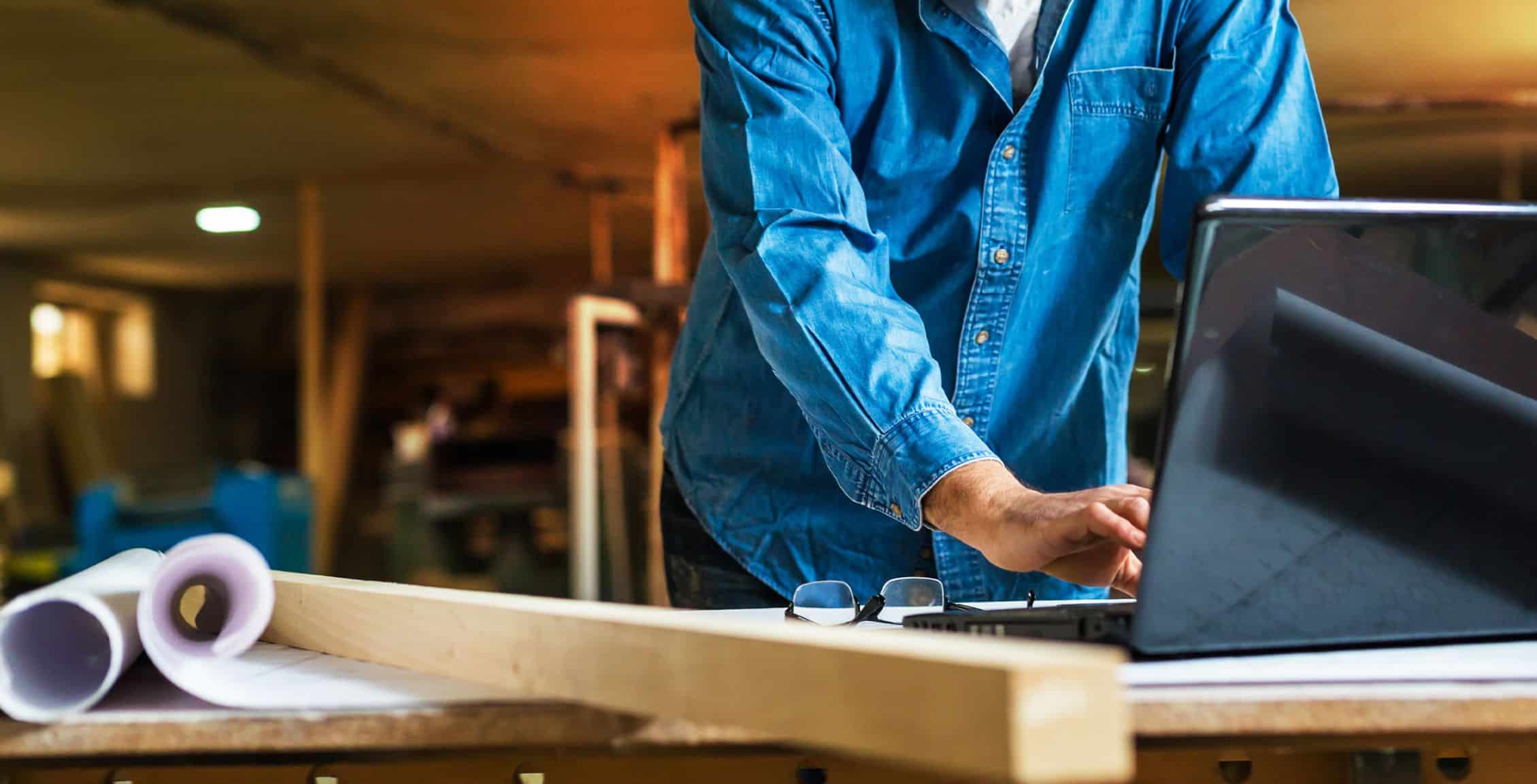 Man on laptop in work room