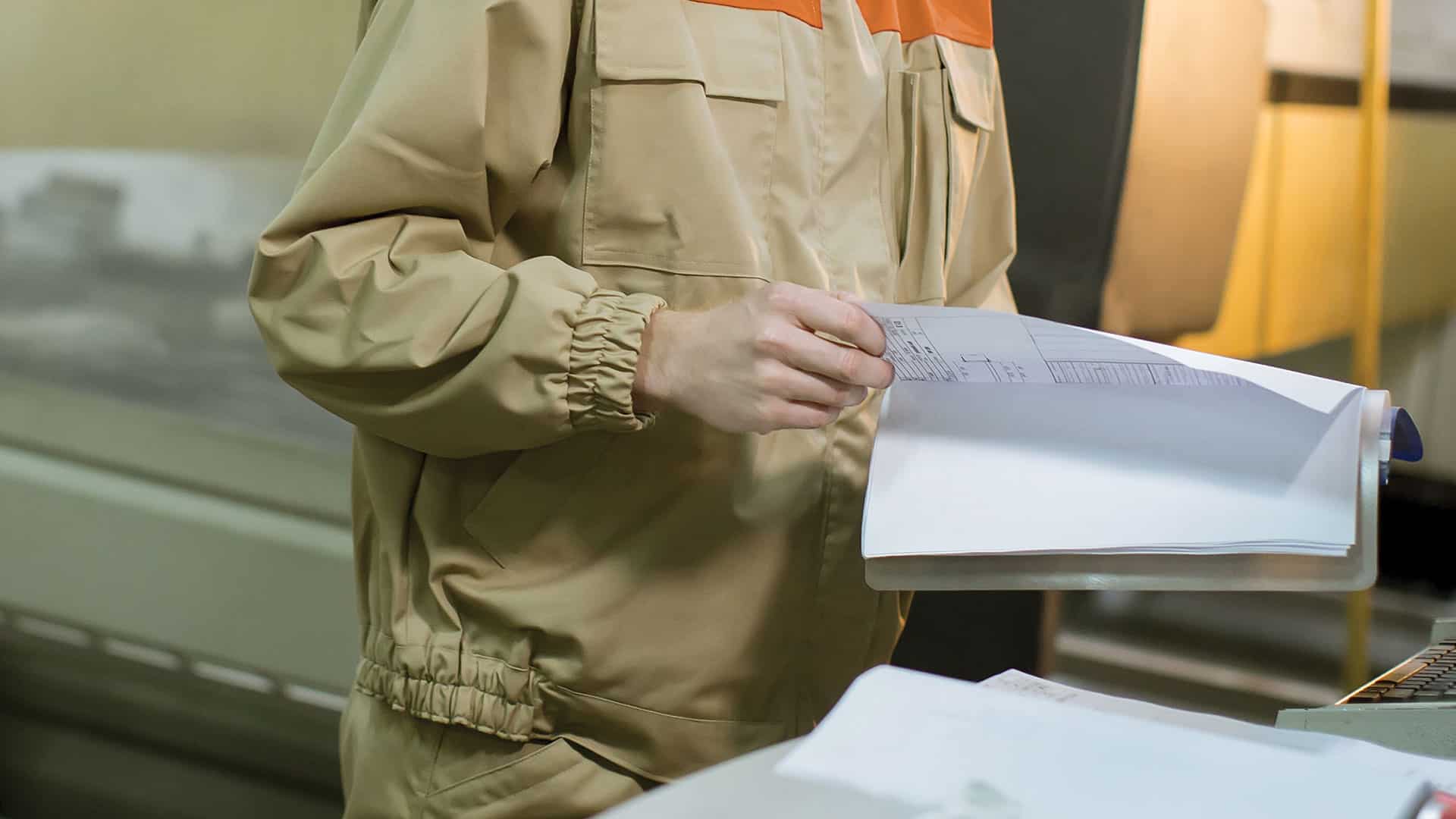 A worker looking through technical manuals