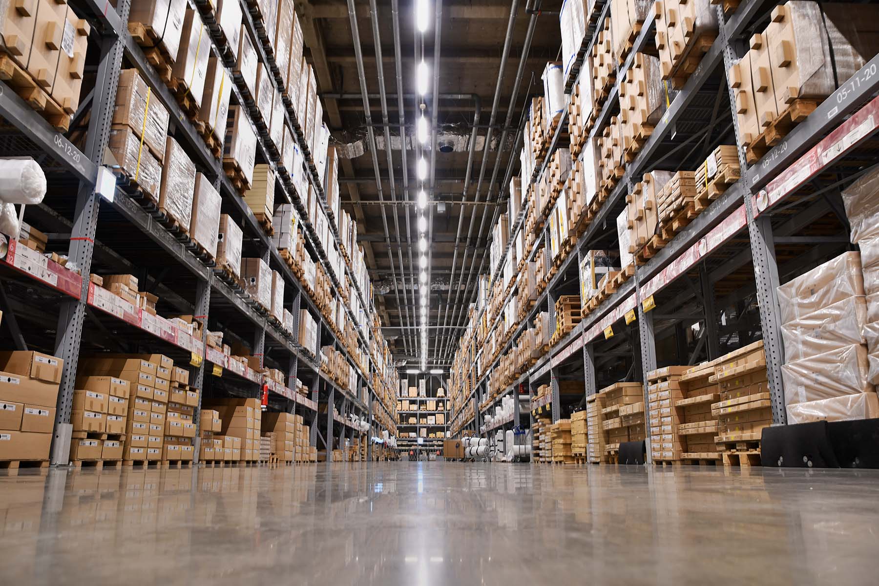 large scale warehouse with pallets of freight stacked along the side
